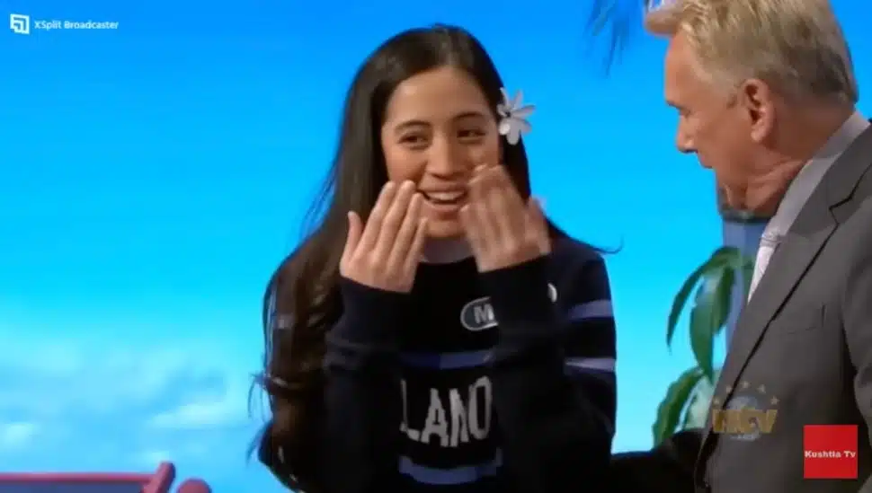 Wheel of Fortune contestant Malia, a Villanova University student, with host Pat Sajak