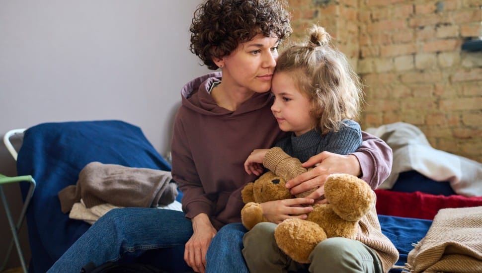 A woman and a young girl in a homeless shelter