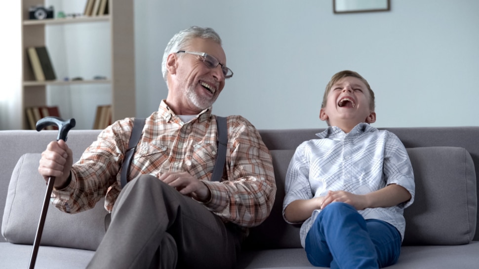 A grandfather laughing with his grandson