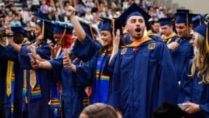 Neumann University students move their tassels and celebrate the moment of graduation.