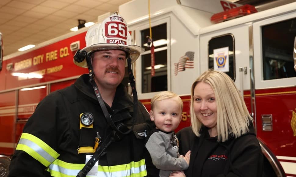 Jon and Nicole Simmons with son JJ, 2, at the Garden City Fire Company station in Wallingford.