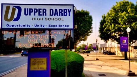 The Upper Darby High School marquee with the school campus in the background