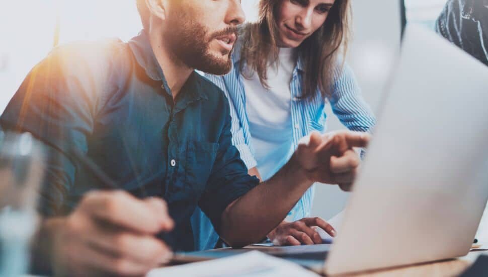 two people looking at laptop screen, digital marketing company