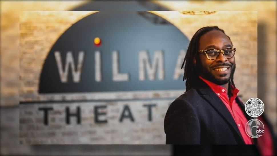 James iJames in front of a Wilma Theater display