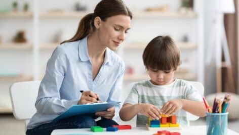 A professional teacher or therapist working with a child.