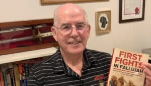 Retired Marine Lt. Col. David E. Kelly of Springfield, with his newest book, “First Fights in Fallujah.”