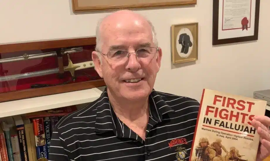 Retired Marine Lt. Col. David E. Kelly of Springfield, with his newest book, “First Fights in Fallujah.”