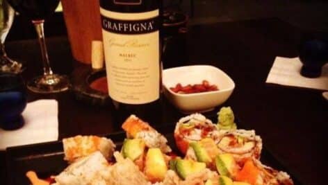 A bottle of wine complementing a meal at Margaret Kuo's restaurant.
