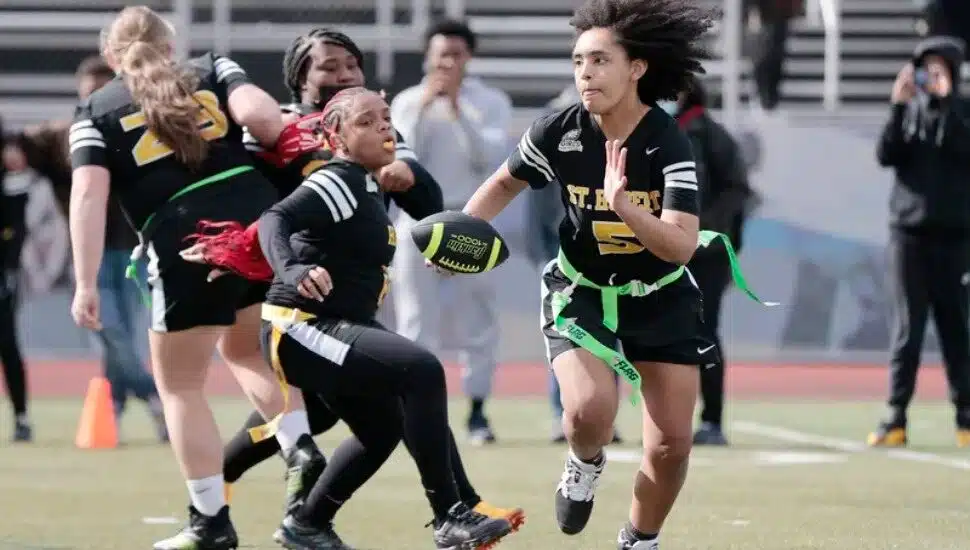 St. Hubert quarterback Mariah Riddick looks for running room in a flag football game against Hill Freedman World Academy.