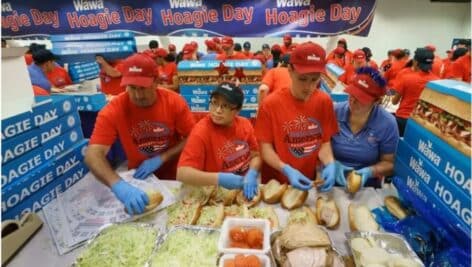 (From left) Rob Mitchell, Sherly D'Alfonso, Seth Williams, and Melissa Williams, make hoagies for Wawa's annual Hoagie Day in 2019.