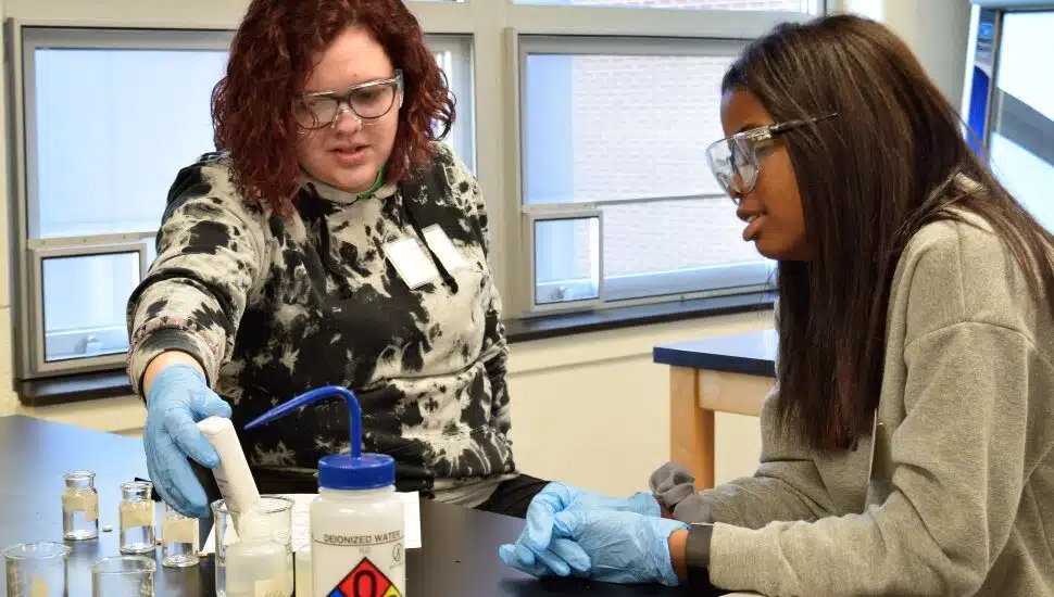 Two high school girls work on a project at a Widener mini-camp for girls.