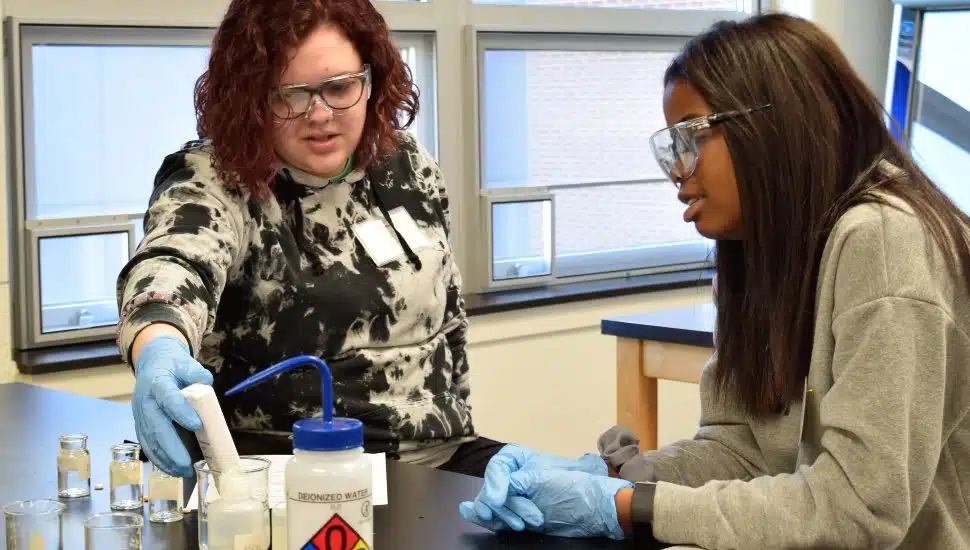 Two high school girls work on a project at a Widener mini-camp for girls.
