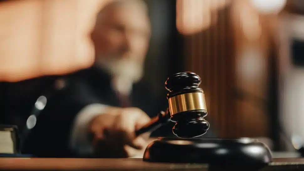 A court ;judge striking a gavel in the courtroom.