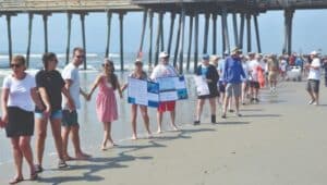 Protesters at the Hands Across the Beaches event July 15 in Ocean City, New Jersey.