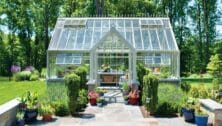 A transformed Delaware County yard with landscaping an a greenhouse.