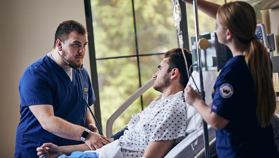 Nursing students with a patient at Widener University School of Nursing.