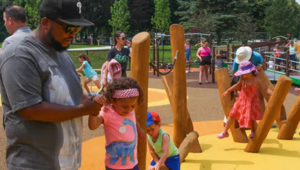 4-year-old Marcella is accompanied by her father Harold at the Rose Tree Park playground.