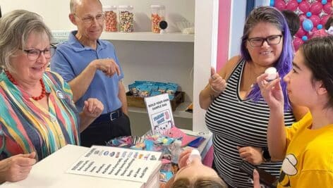 Bonnie and Frank Magliochetti, left, parents of Katie Malenich, watch Isabella and Sophia Schiff try some TAFF Treats