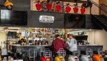 The décor at Exit 13 gives off a playful vibe with local license plates, and motorized European scooters adorning the walls and Vespa seats as bar stools.