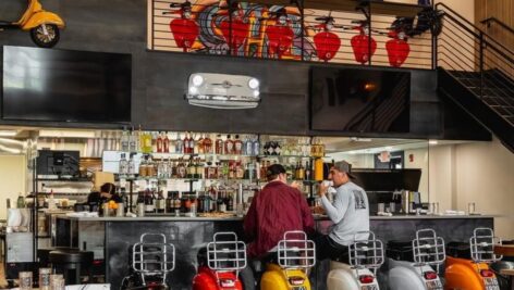 The décor at Exit 13 gives off a playful vibe with local license plates, and motorized European scooters adorning the walls and Vespa seats as bar stools.