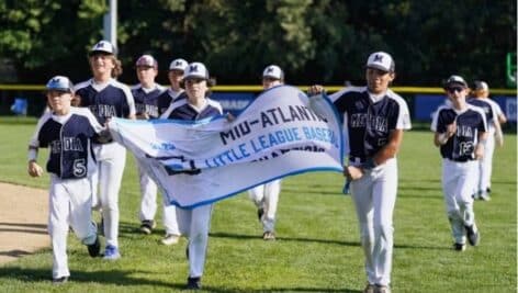The Media Little League team waves the banner announcing their Mid-Atlantic championship win
