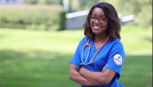 female nursing student in blue scrubs