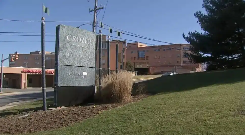 A hospital in the Crozer Health system with the Crozer sign in the foreground.