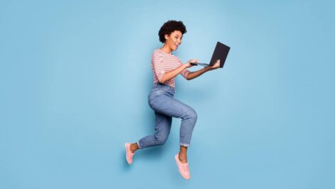 woman mid air holding laptop