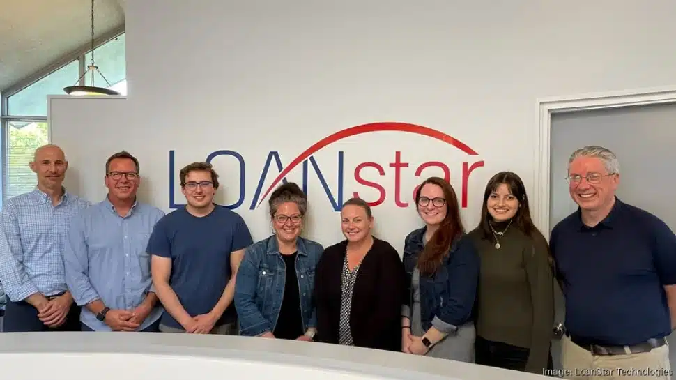 LoanStar employees line up in front of the company's logo. The company is on the Inc 5000 list in 2023.