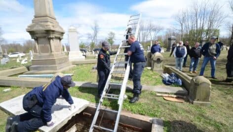Investigators examine a crypt at Mount Moriah Cemetery in Yeadon.