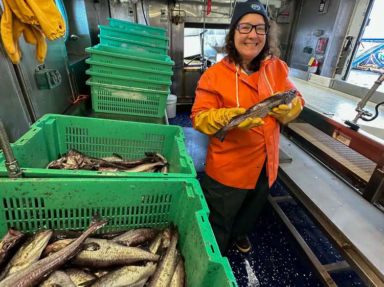 Laura Guertin, distinguished professor of Earth science at Penn State Brandywine, holds a walleye pollock, as part of her time aboard a research ship in the Gulf of Alaska assessing the walleye pollock population.