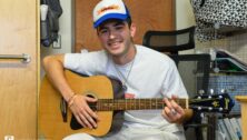 Danny Vitale plays his guitar and sings in his dorm room at Penn State University