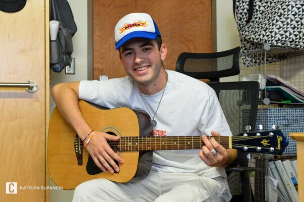 Danny Vitale plays his guitar and sings in his dorm room at Penn State University
