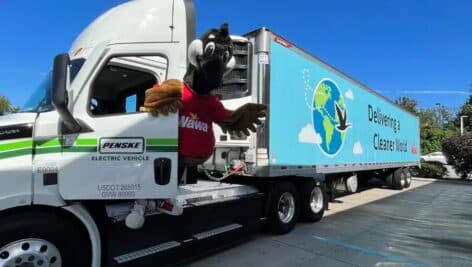 Wawa's mascot hangs out the cab of a new electric delivery truck being test piloted for Wawa deliveries.