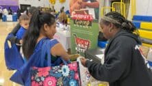 Desiree LaMarr-Murphy of Murphy’s Giving Market distributes fresh produce to attendants of the Community Baby Shower