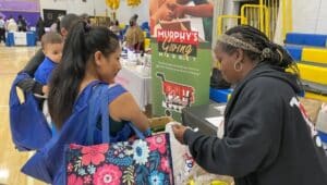Desiree LaMarr-Murphy of Murphy’s Giving Market distributes fresh produce to attendants of the Community Baby Shower
