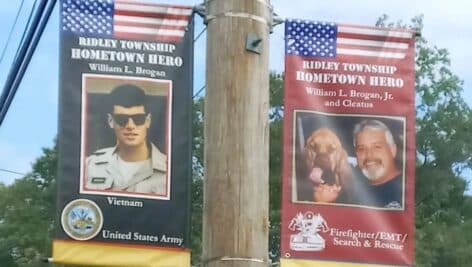 side by side banners in ridley honoring bill brogan senior, a veteran, and billy borgan junior (and his dog Cleatus) a first responder,.