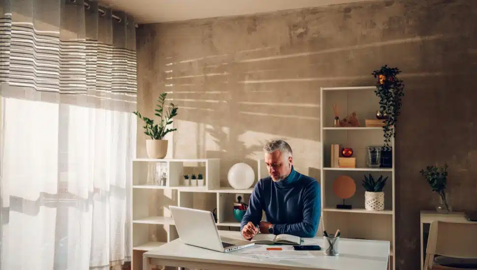 A middle-aged businessman working at home.