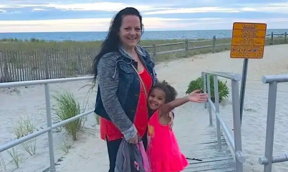 Karen Barnes and an unidentified young girl near a beach.