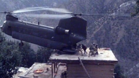A CH-47 Chinook helicopter lands on the roof of a house in northeastern Afghanistan to evacuate detainees.