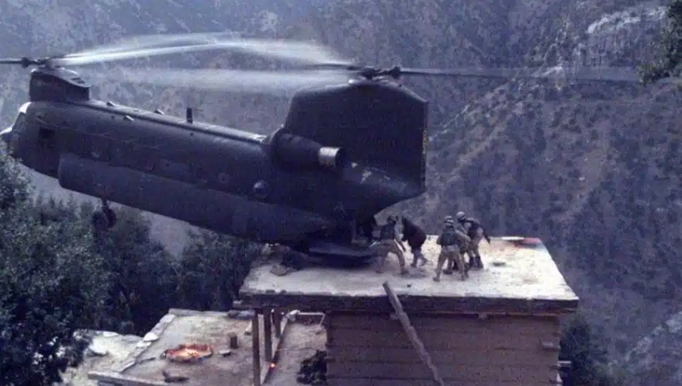 A CH-47 Chinook helicopter lands on the roof of a house in northeastern Afghanistan to evacuate detainees.