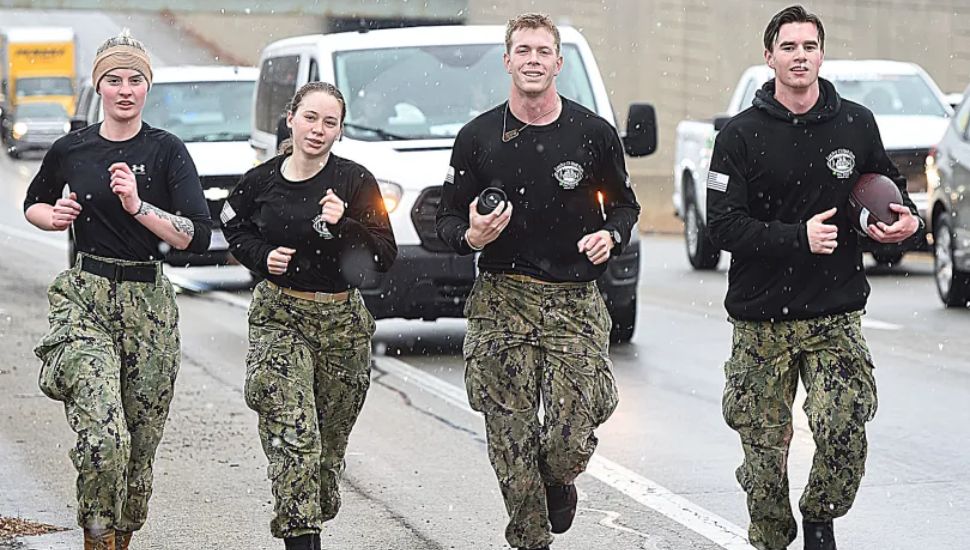 Along Route 1 in Glen Mills on Wednesday are, from left, Navy midshipmen Ashleigh Ahern of Boston; Clarissa Layland of Granbury, Texas; Luke Sweeney of Severna Park, Maryland; and Campbell Holliday of Washington D.C.