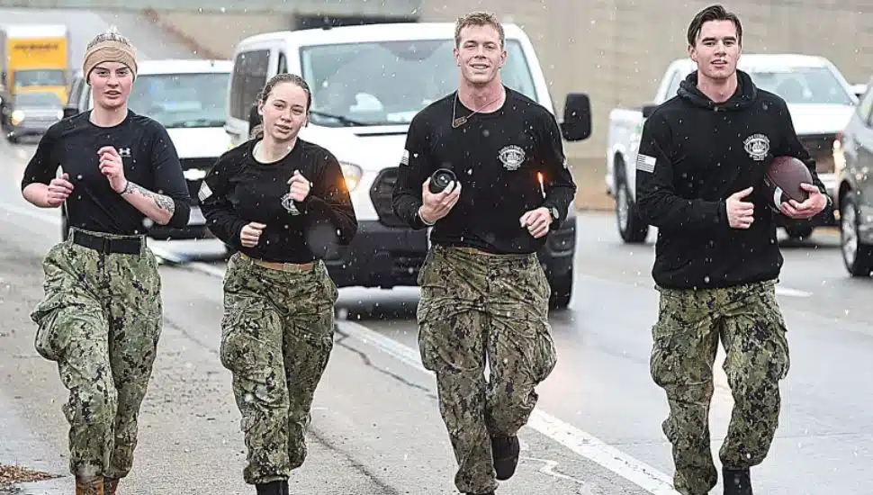 Along Route 1 in Glen Mills on Wednesday are, from left, Navy midshipmen Ashleigh Ahern of Boston; Clarissa Layland of Granbury, Texas; Luke Sweeney of Severna Park, Maryland; and Campbell Holliday of Washington D.C.