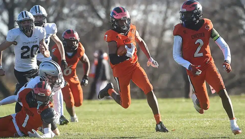 Chester’s Quamere Cosby, center, has support as he runs the opening kick of the second half for a touchdown in the District 1 Class 5A final Saturday at Chester Athletic Field.