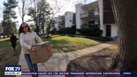 A volunteer delivers a holiday care package to a family in need.