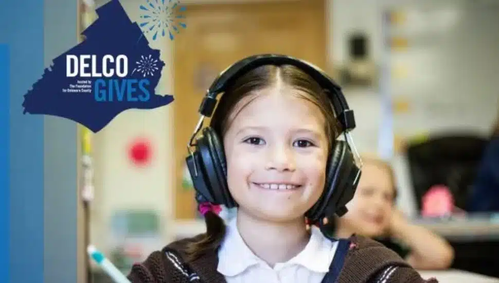 A happy child wearing headphones with a Delco Gives icon to her left.