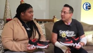 Dr. Claudio V. Cerullo provides a student with a new pair of sneakers.