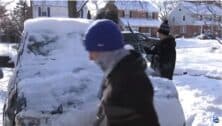 Members of the Springfield High School lacrosse team help a neighbor dig out from the snow.