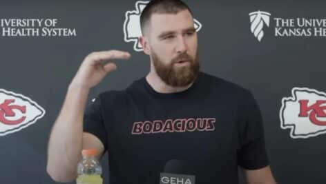 Travis Kelce speaking at a Friday press conference about rumors of his brother's retirement