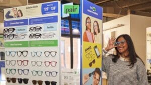 A customer tries on top frames at a Pair Eyewear in-person display.
